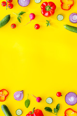 Cook frame with fresh vegetables on yellow background top view space for text