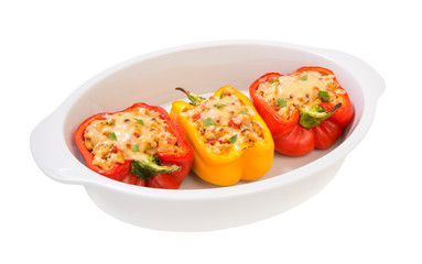 colorful baked with cheese stuffed peppers with minced turkey and vegetables in a white casserole baking isolated on a white background