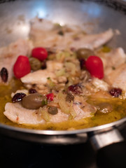 Sautéed cod with tomato, raisins, pine nuts, celery, red onion, oil, pepper and olives and olives