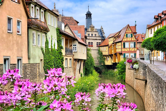 Picturesque old buildings and flowers lining a canal in the town of Marktbreit, Bavaria, Germany