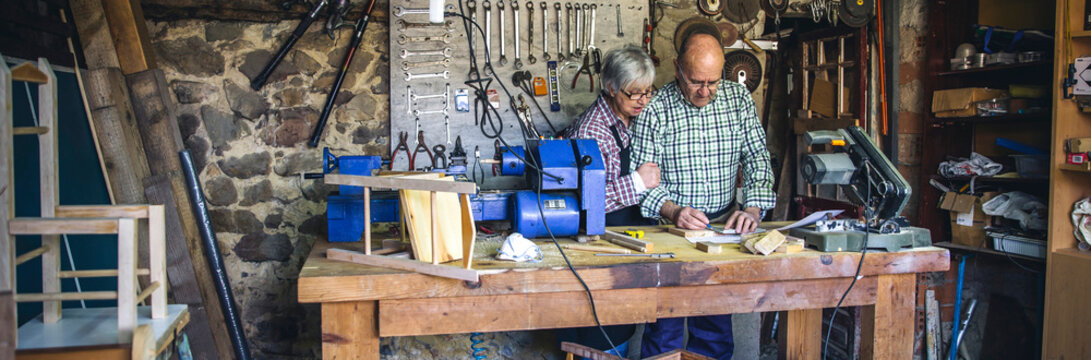 Senior couple working in a carpentry workshop