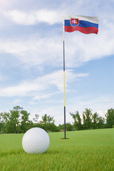 Obraz premium Slovakia flag on golf course putting green with a ball near the hole