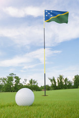 Obraz premium Solomon Islands flag on golf course putting green with a ball near the hole