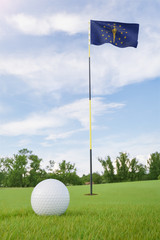Obraz premium Indiana flag on golf course putting green with a ball near the hole