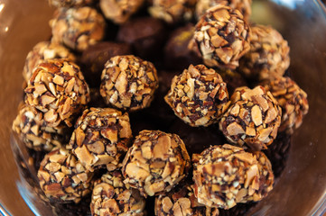 A bowl of round nut covered candies.