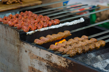 Cooking adana kebabs on a grill in restaurant 