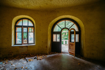 Old ruined abandoned mansion interior, vaulted window and door