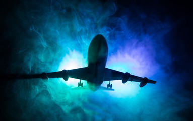 Artwork decoration. White passenger plane ready to taking off from airport runway. Silhouette of Aircraft during night time.
