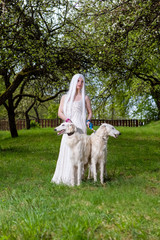 Female elf with Long White Hair Holding A Pair of Greyhounds in Forest Outdoors.