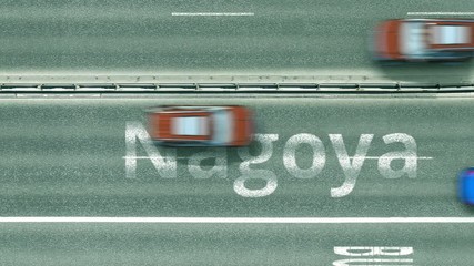Aerial down view of the motorway with cars revealing Nagoya caption. Car travel to Japan intro clip