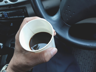 black coffee hot drink in paper cup in car