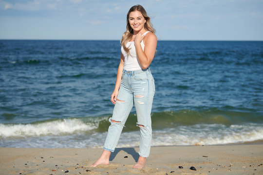 Beautiful lovely couple wearing jeans,posing at summer beach Stock Photo by  ©DariYad 302877068