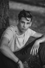 Portrait of a handsome teenager outdoors. A young man. Black and white photo