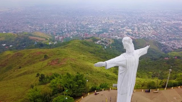 Aerial shot around the Cristo Rey statue in Cali, Colombia.