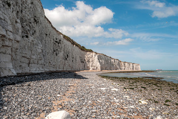 Popular tourist attraction and relax by the ocean concept with wide chalk wall made of white cliffs...