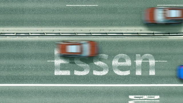 Aerial top down view of the road with cars revealing Essen caption. Car travel in Germany conceptual clip