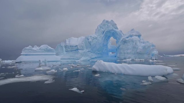 Antarctica Port Charcot Ice Arch reflection iceberg illustrates fragile global warming.