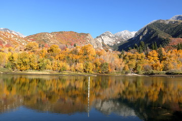 Snowcapped Wasatch range reflects in the waters of Bells Canyon Reservoir near Sandy, Utah