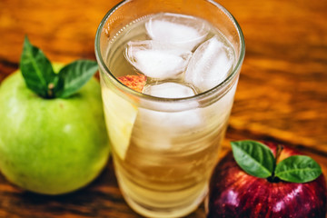 Apple spritzer (apfelschorle) pitcher, Glass pitcher of homemade spritzer served with crushed ice and apple slices. Jug full of non-alcoholic sparkling and cold carbonated apple juice.