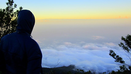 silhouette of man on top of mountain