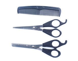 Comb with scissors  on a white background