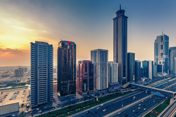 Naklejka na ściany i meble Downtown Dubai at sunset. Scenic view on highways and skyscrapers.