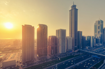 Downtown Dubai at sunset. Scenic view on highways and skyscrapers.