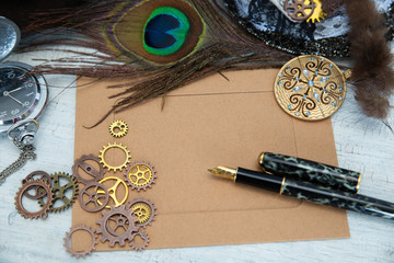 An empty vintage card for a close-up message, with gears pen lock and ornaments lie on a light background. Can be used for steampunk and mechanical design.