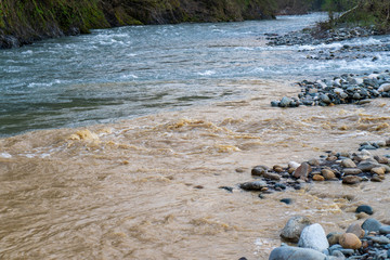 Image of a mountain river with colorful water.