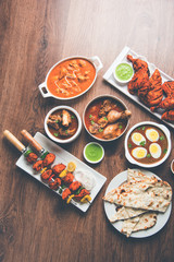 Assorted Indian Non Vegetarian food recipe served in a group. Includes Chicken Curry, Mutton Masala, Anda/egg curry, Butter chicken, biryani, tandoori murg, chicken-tikka and naan/roti