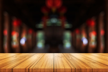 Empty wooden table top with blurred coffee shop or restaurant interior background. Abstract background can be used product display.