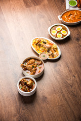 Assorted Indian Non Vegetarian food recipe served in a group. Includes Chicken Curry, Mutton Masala, Anda/egg curry, Butter chicken, biryani, tandoori murg, chicken-tikka and naan/roti