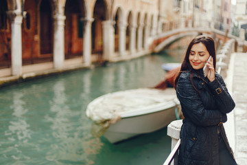 girl talking on the phone and taking pictures in Venice Italy