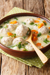 Tasty Bulgarian soup topcheta with meatballs close-up in a bowl. vertical