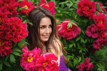 Obraz na płótnie Canvas Close up photo of beautiful young woman surrounded by flowers