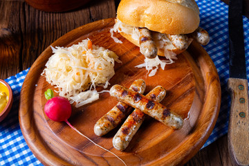 rustic Thuringian bratwurst with sauerkraut and roll