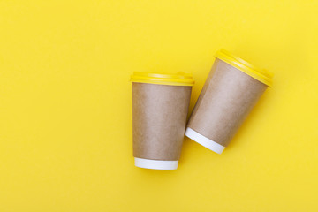 Morning coffee cup concept. Coffee to go on yellow background.