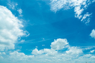 Naklejka na ściany i meble Beautiful blue sky and white cumulus clouds abstract background. Cloudscape background. Blue sky and fluffy white clouds on sunny day. Nature weather. Bright day sky for happy day and space.