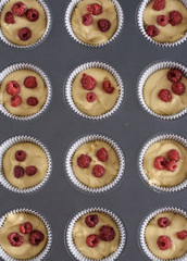 Delicious flavored cupcake with raspberries, white cream, and chocolate icing.