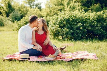 Couple in a field. Girl in a red dress. Man in a white shirt
