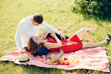 Couple in a field. Girl in a red dress. Man in a white shirt