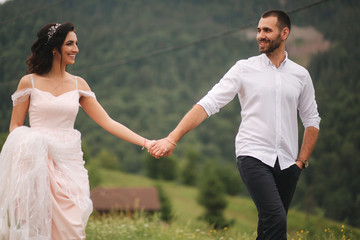 Beautiful wedding couple in Carpathian mountains. Handsome man with attractive woman