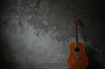 Fototapeta na wymiar Guitar on a cement background