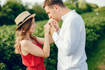 Couple in a field. Girl in a red dress. Man in a white shirt