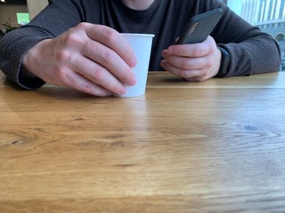 hand of man working on smartphone