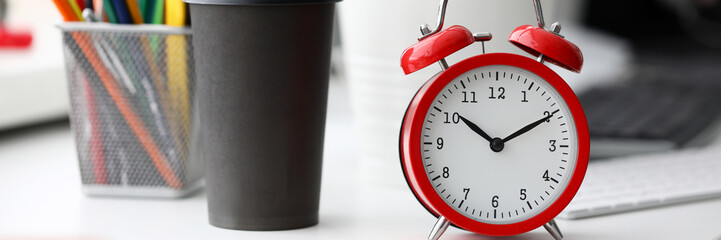 Red alarm clock on office table