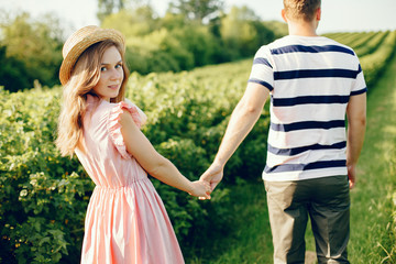 Fototapeta premium Couple in a field. Girl in a pink dress. Man in a white shirt