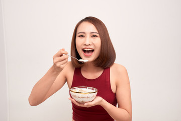 Woman in gym eating healthy after exercise