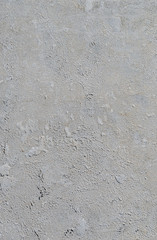Urban concrete wall background with grooves and bubbles. Cement gray wall. Urban and industrialization art concept. Texture like concrete, stone, cement, plaster.. Poster mockup. Сloseup studio shot.