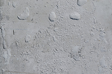 Urban concrete wall background with grooves and bubbles. Cement gray wall. Urban and industrialization art concept. Texture like concrete, stone, cement, plaster.. Poster mockup. Сloseup studio shot.